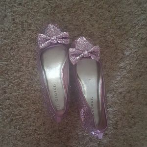 Girls glitter heels with bow on shoes.